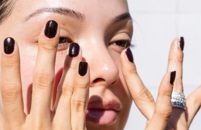 a woman touching her dark circles