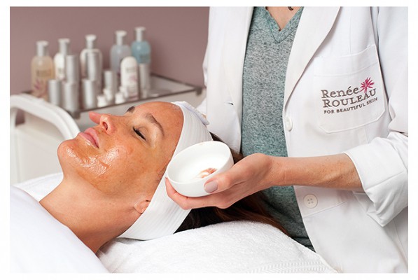 Renee applying a chemical peel on a clients face
