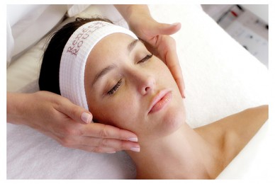 an esthetician prepping a woman for a facial