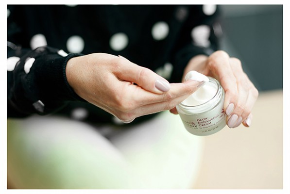 woman's hand scooping out Renee Rouleau's glow enhancing cream