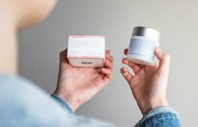 woman comparing two skincare ingredient labels