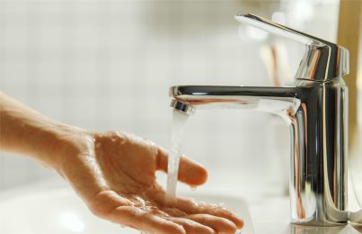 Hand under running tap water