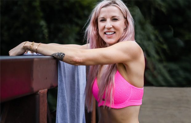 renee rouleau smiling in pink swimsuit